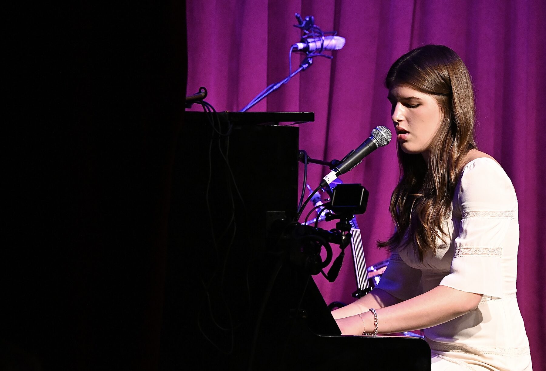 Carolina Chase performing live, at piano