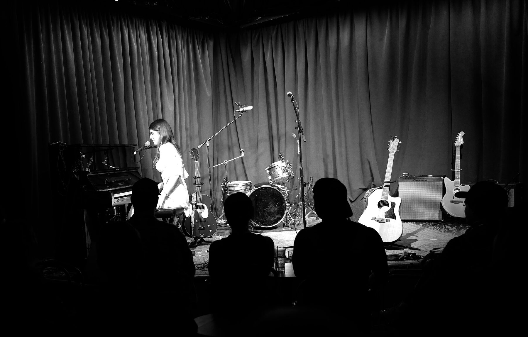 Carolina Chase on stage, wide shot with audience